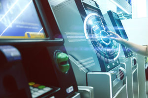 ATM Company NJ image of hand using touch screen at banking machine with circular graphic in white where fingers are touching the screen.