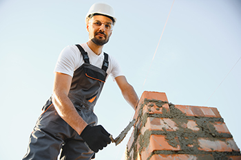 Belmar chimney service worker Belmar fireplace service worker working with bricks